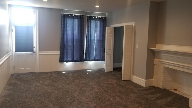 interior space with dark colored carpet and recessed lighting