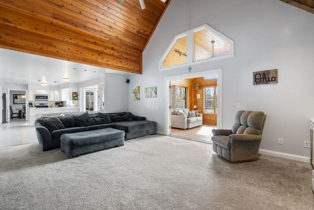 living room with high vaulted ceiling, wooden ceiling, light colored carpet, and baseboards