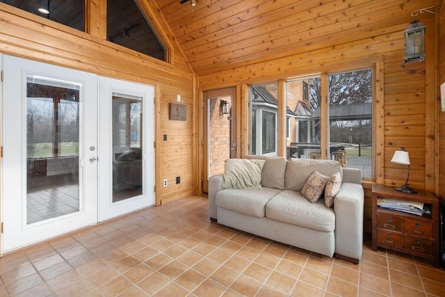 sunroom featuring french doors, a healthy amount of sunlight, vaulted ceiling, and wooden ceiling