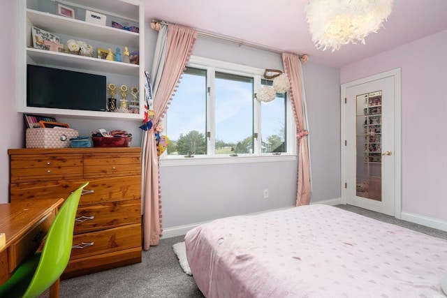 bedroom with carpet floors, a notable chandelier, and baseboards