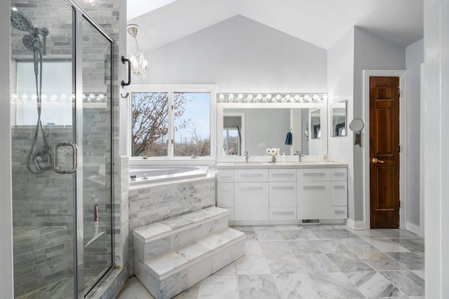 full bathroom featuring a garden tub, double vanity, a stall shower, vaulted ceiling, and a sink