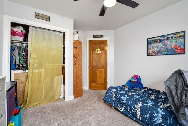 carpeted bedroom with a ceiling fan and a closet