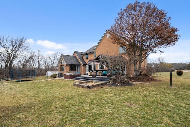 back of house with a yard, a trampoline, a vegetable garden, and central air condition unit