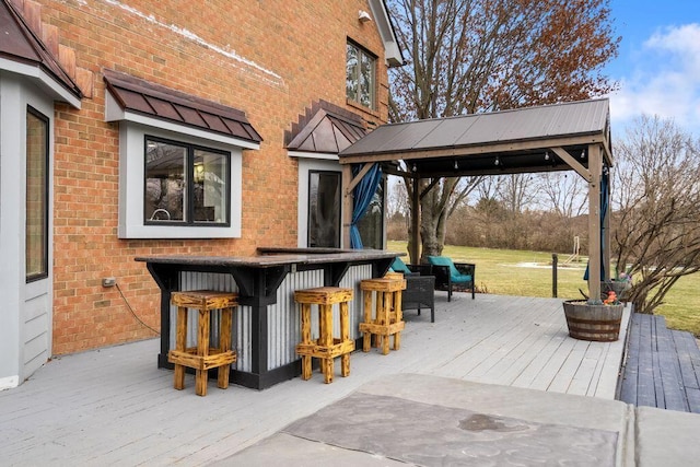 wooden deck with outdoor dry bar and a gazebo