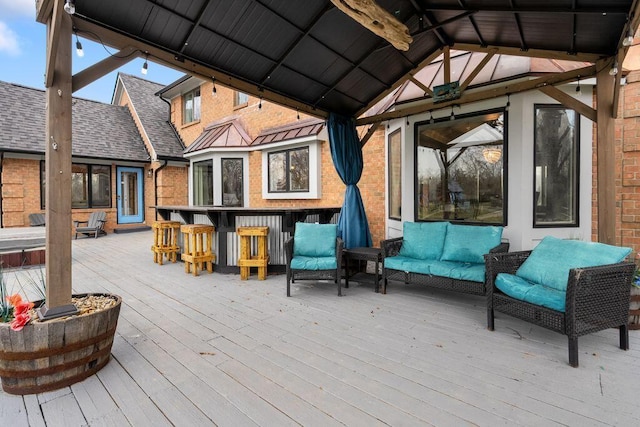 wooden terrace with outdoor dry bar, a gazebo, and an outdoor hangout area