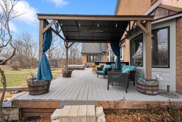 wooden deck featuring an outdoor hangout area and a covered hot tub