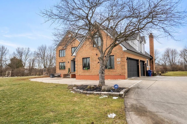 view of property exterior with a garage, brick siding, driveway, a lawn, and a chimney