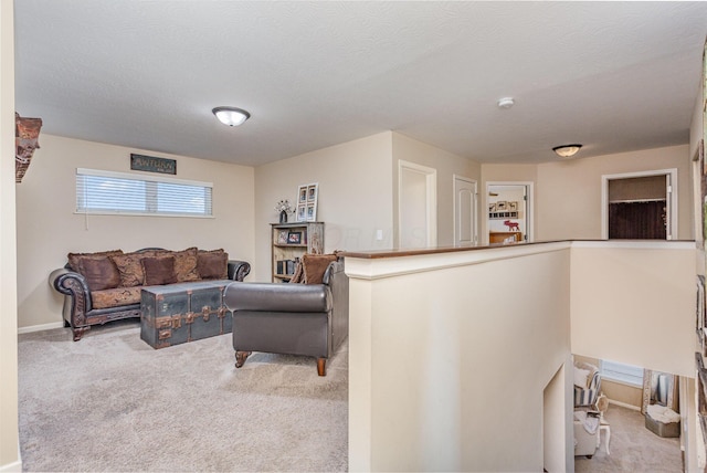 living room featuring light carpet and a textured ceiling