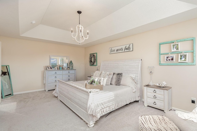 bedroom featuring a chandelier, a raised ceiling, light colored carpet, and baseboards