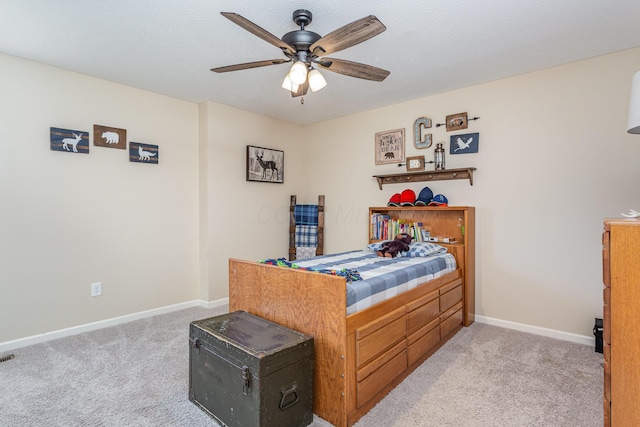 bedroom with light colored carpet, ceiling fan, a textured ceiling, and baseboards