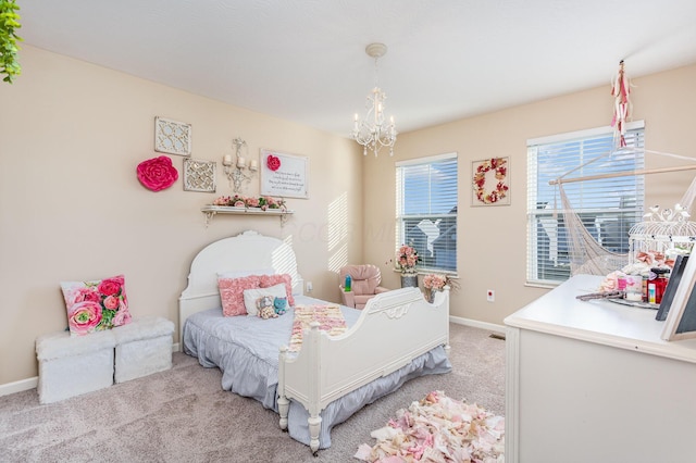 bedroom featuring an inviting chandelier, baseboards, and light colored carpet