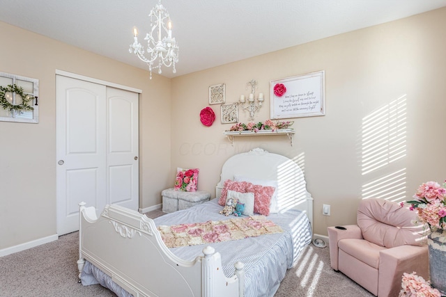 bedroom featuring baseboards, a closet, a notable chandelier, and light colored carpet