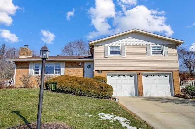 tri-level home with brick siding, a chimney, an attached garage, driveway, and a front lawn