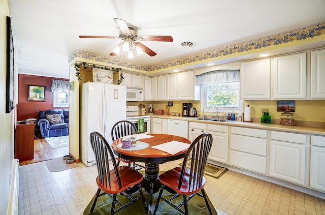 dining room featuring a ceiling fan, a baseboard radiator, visible vents, and light floors