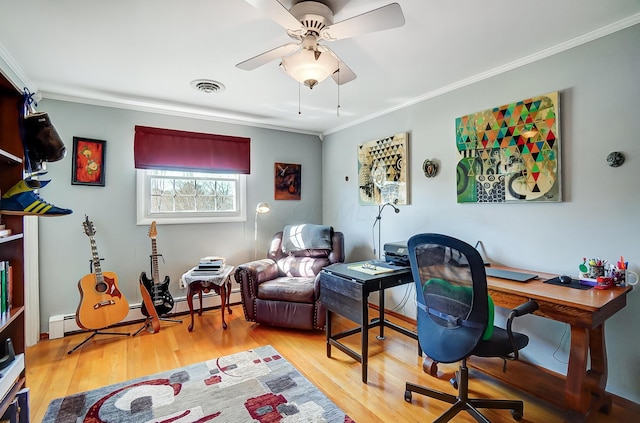 office space featuring light wood-type flooring, visible vents, a ceiling fan, and ornamental molding