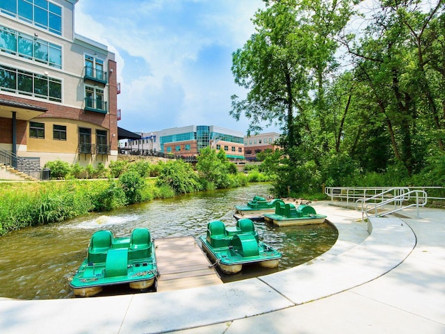 view of home's community with a dock and a water view