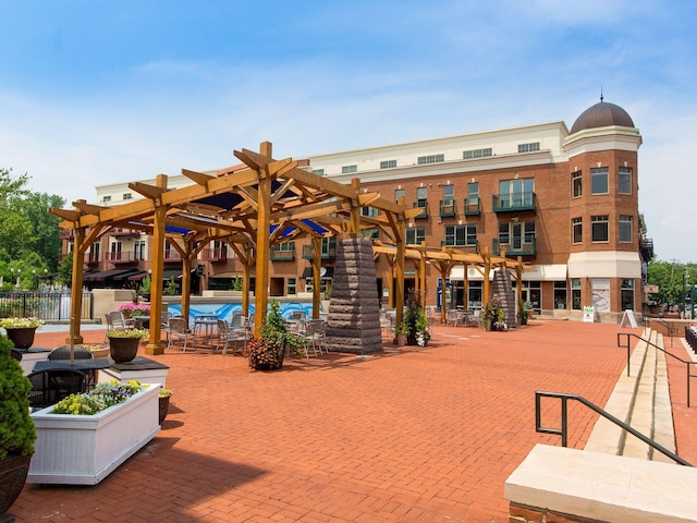 view of community with a patio, fence, and a pergola