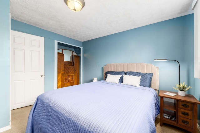 bedroom with a textured ceiling and carpet