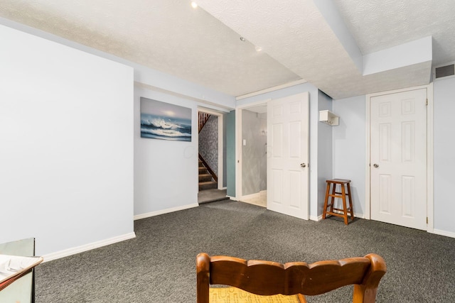 interior space with baseboards, visible vents, stairway, a textured ceiling, and carpet flooring