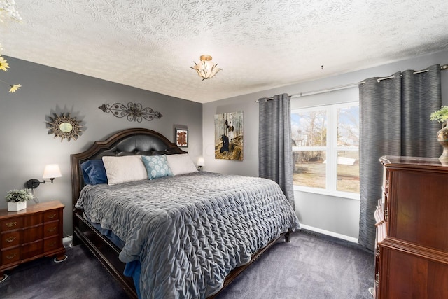 bedroom featuring a textured ceiling, carpet floors, and baseboards