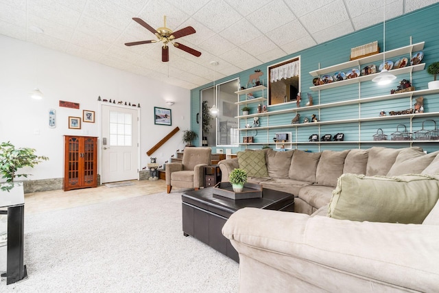 carpeted living room with a ceiling fan