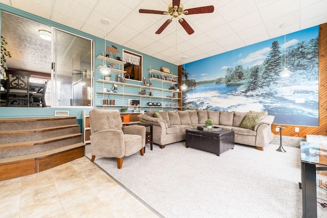 living room featuring a paneled ceiling and a ceiling fan