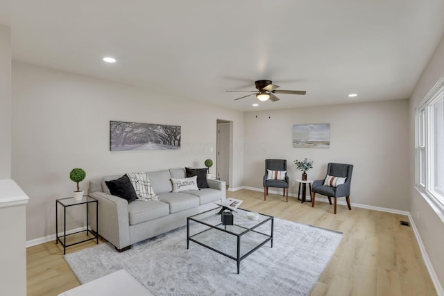 living area featuring visible vents, baseboards, light wood-style flooring, and recessed lighting