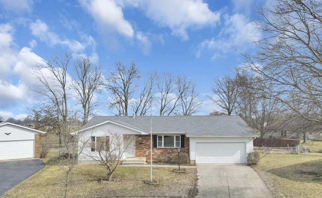 view of front facade with a garage, roof with shingles, and brick siding