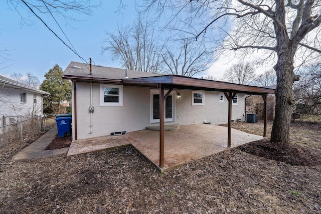 back of house featuring central air condition unit, a patio area, fence, and stucco siding