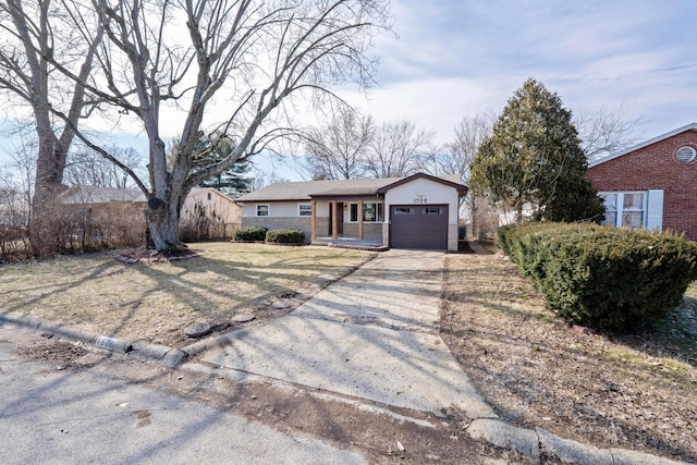 single story home featuring a porch, an attached garage, driveway, stone siding, and stucco siding