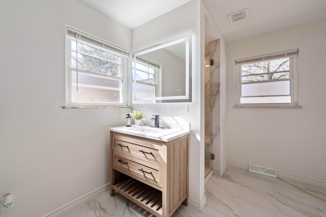 full bath with marble finish floor, a stall shower, visible vents, and a healthy amount of sunlight