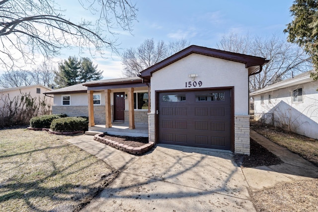 view of front of house featuring driveway, an attached garage, and stucco siding