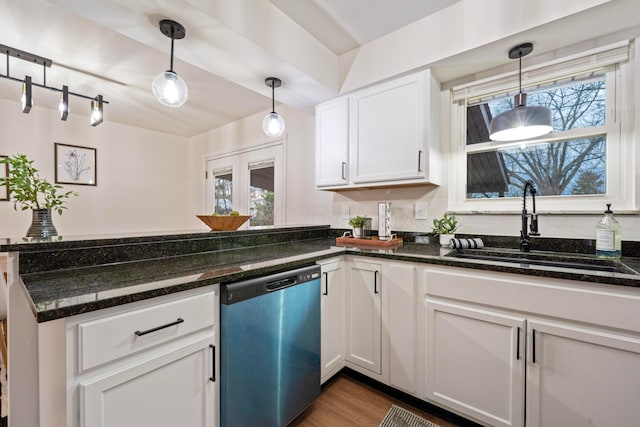 kitchen featuring white cabinets, dishwasher, decorative light fixtures, a peninsula, and a sink