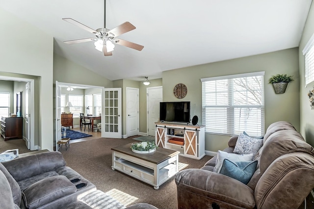 living room with lofted ceiling, carpet, a ceiling fan, and a healthy amount of sunlight