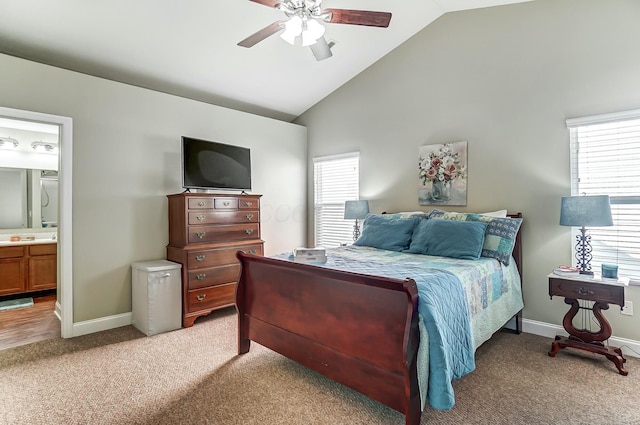 bedroom featuring light colored carpet, baseboards, and ensuite bathroom