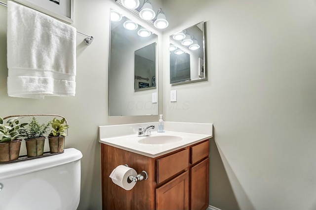 bathroom featuring toilet and vanity