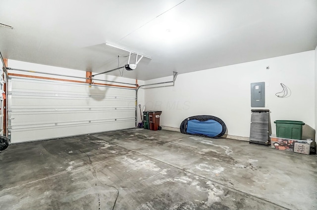 garage with a garage door opener and electric panel