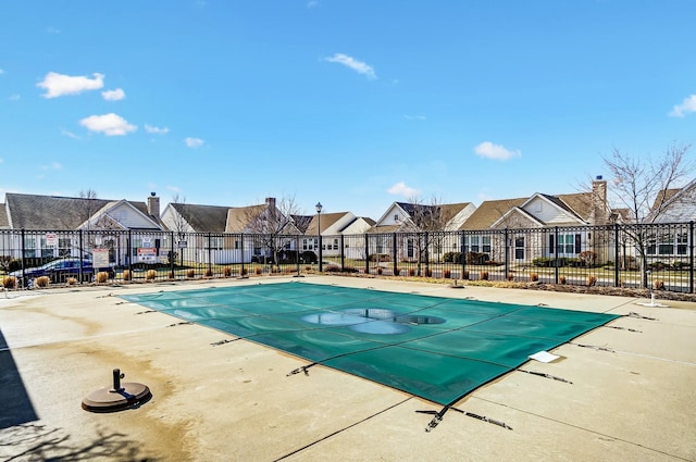 pool featuring a residential view and fence