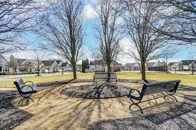 view of home's community with a residential view and a lawn