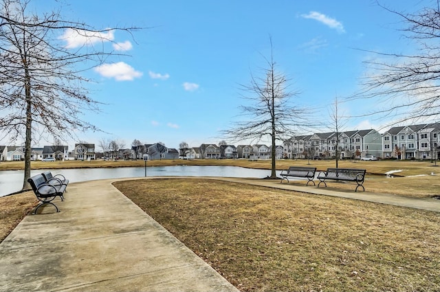 view of property's community with a residential view, a water view, and a yard