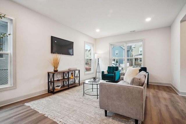 living room with recessed lighting, wood finished floors, and baseboards