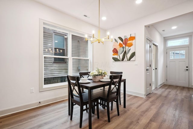 dining area featuring baseboards, a chandelier, wood finished floors, and recessed lighting