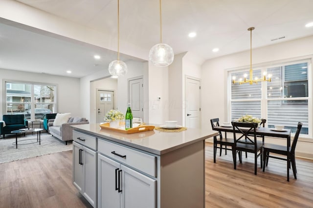 kitchen featuring hanging light fixtures, recessed lighting, light wood-style flooring, and a center island