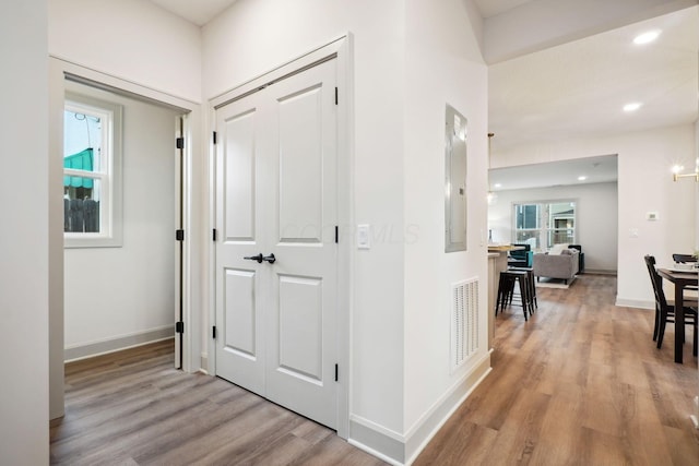 hall featuring recessed lighting, wood finished floors, visible vents, and baseboards