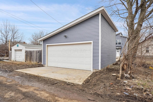 detached garage featuring fence