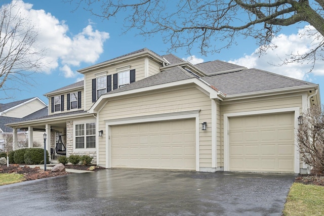 view of front facade featuring a garage, aphalt driveway, and roof with shingles