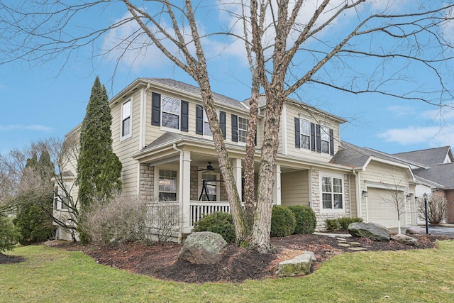 view of front of home featuring a porch, a front yard, an attached garage, and a ceiling fan