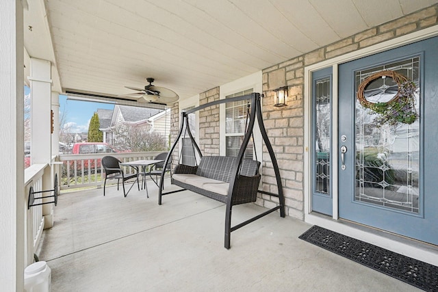 view of patio with ceiling fan and a porch