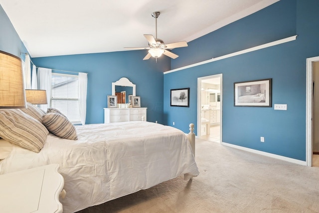 carpeted bedroom with vaulted ceiling, ceiling fan, connected bathroom, and baseboards