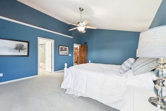 bedroom with ensuite bathroom, a ceiling fan, baseboards, vaulted ceiling, and carpet